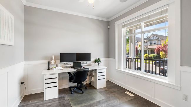Office space featuring a decorative wall, crown molding, a wainscoted wall, and dark wood-type flooring | Image 6