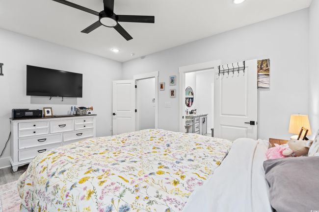 Bedroom with wood finished floors, recessed lighting, and a ceiling fan | Image 19