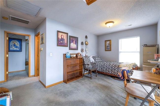 Carpeted bedroom featuring baseboards and a textured ceiling | Image 28