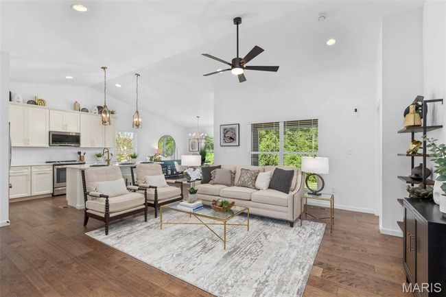Living area featuring healthy amount of natural light, high vaulted ceiling, a ceiling fan, recessed lighting, and dark wood finished floors | Image 9