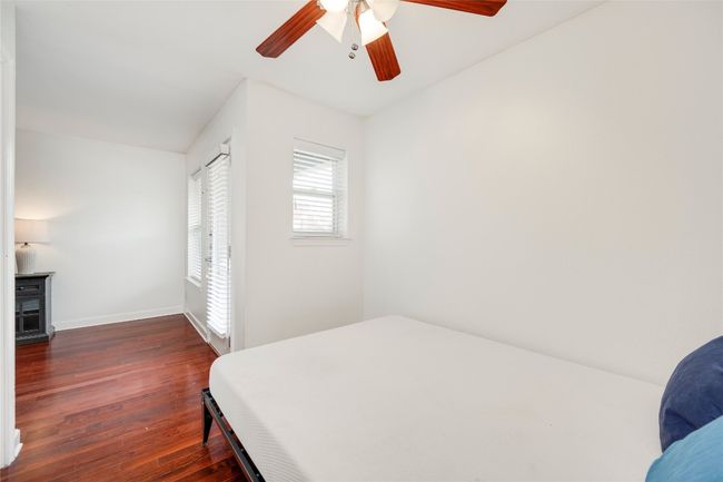 Bedroom featuring dark wood-type flooring, baseboards, and ceiling fan | Image 35