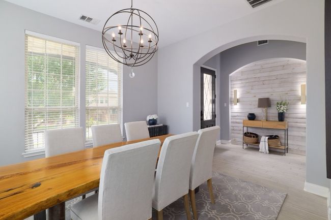 Dining space with a chandelier, arched walkways, baseboards, and wood finished floors | Image 13