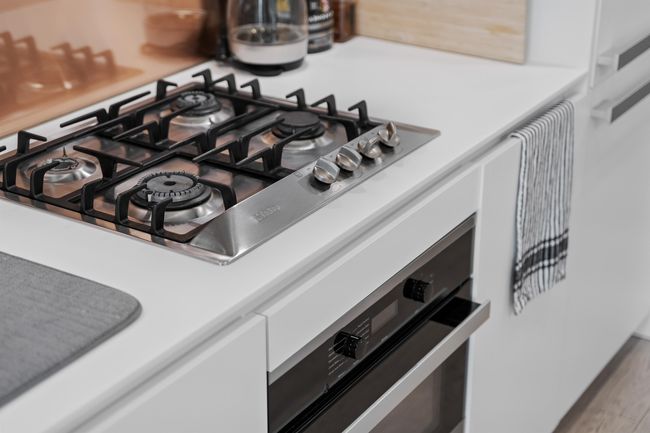 Kitchen view of stainless steel gas stovetop and wall oven | Image 11