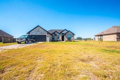 French provincial home featuring a garage and a front yard | Image 2