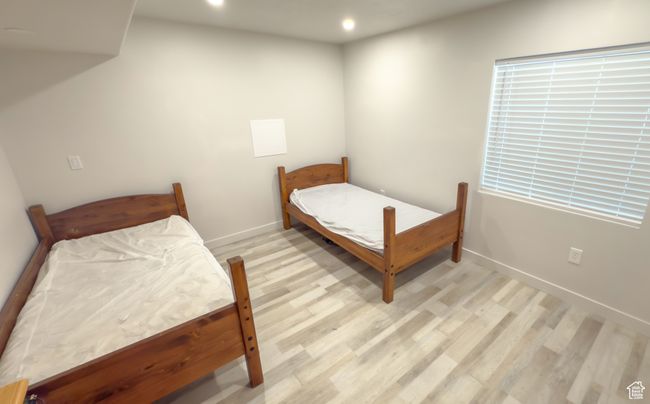 Bedroom with light wood finished floors and recessed lighting | Image 22