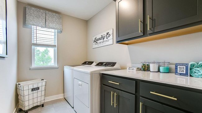 Upper floor laundry with cabinetry and countertop space gives plenty of room for storage, sorting and folding! A window lets in natural light, making laundry a little more bearable! | Image 34