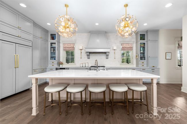 The spacious island offers plenty of seating for gathering with the chef. | Image 6