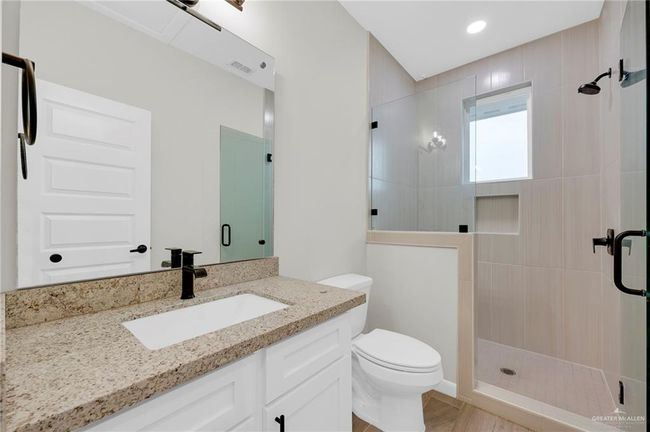 Full bath with vanity, a shower stall, and a sink | Image 16