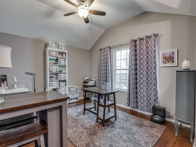 Office space with vaulted ceiling, ceiling fan, wood finished floors, and baseboards | Image 6