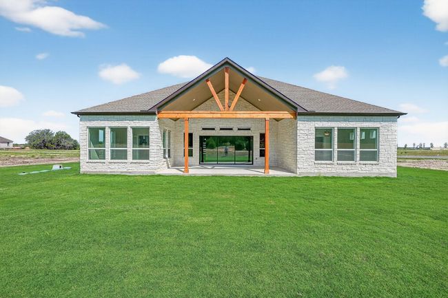 Back of property with a patio, a yard, stone siding, and brick siding | Image 28
