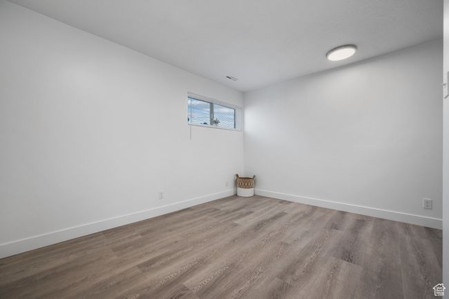 Unfurnished room featuring wood finished floors and baseboards | Image 11