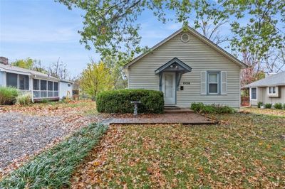 View of front of property featuring a darling entry, front lawn, landscaping, mailbox and shutters | Image 1