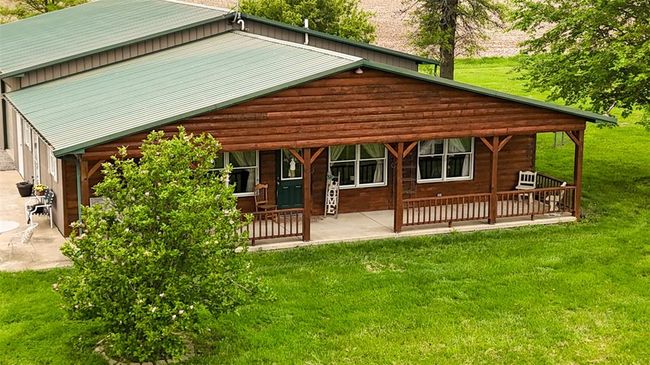 Front view of property featuring a yard, a patio area, and metal roof | Image 14