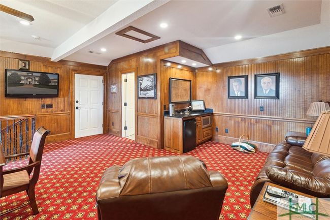 At the top of the stairs, the door to the right is the half bath. The door on the left is a second attic access. | Image 38