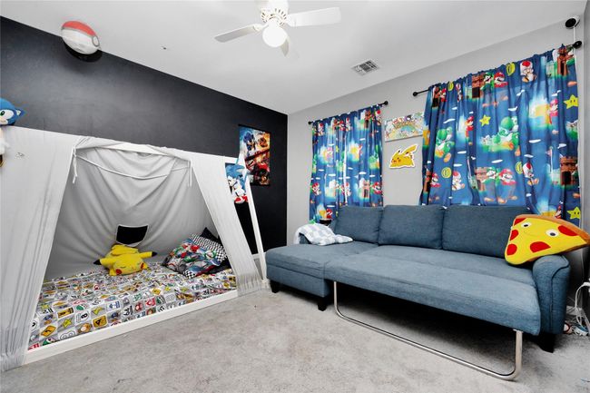 Bedroom featuring a ceiling fan, visible vents, and carpet flooring | Image 14