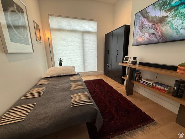 Bedroom with light wood-style flooring | Image 42