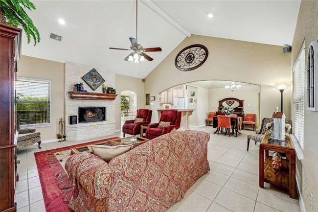 Beautiful stone fireplace is a focal point of the living room. | Image 4