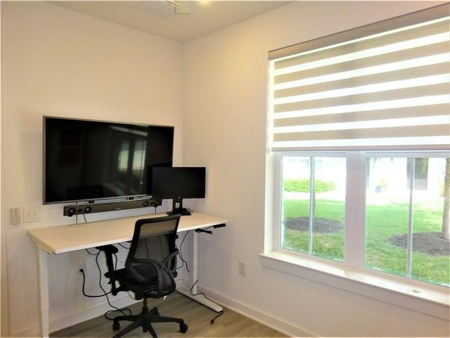 Office area with wood finished floors and baseboards | Image 12