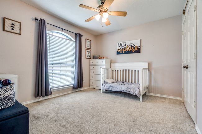 Carpeted bedroom with baseboards, a ceiling fan, and a closet | Image 27