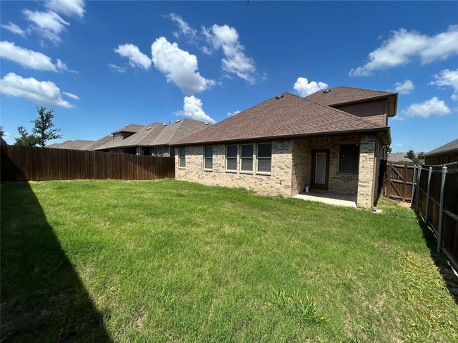 Back of house with a shingled roof, brick siding, and a patio area | Image 30