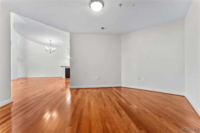 Spare room with an inviting chandelier, light wood-style floors, and baseboards | Image 18