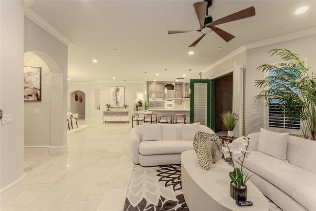 Living area with arched walkways, ceiling fan, recessed lighting, and ornamental molding | Image 21
