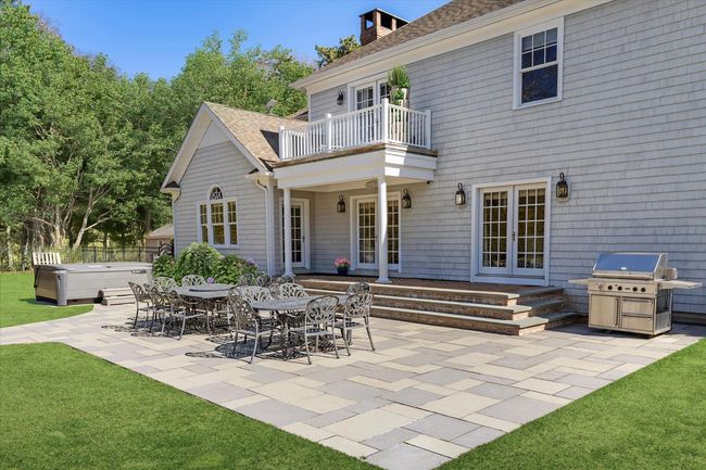 View of patio featuring a hot tub, french doors, area for grilling, and a balcony | Image 39
