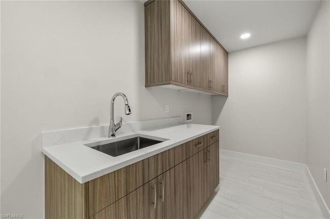 Kitchen with sink and light tile patterned flooring | Image 45