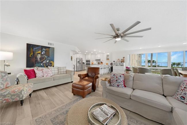 Living room featuring light hardwood / wood-style floors and ceiling fan | Image 17