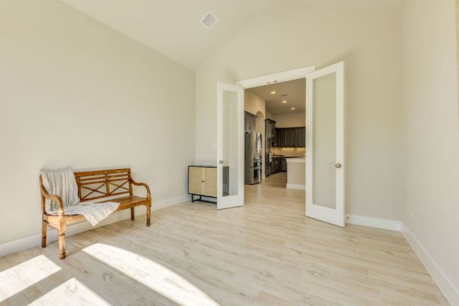 Office with french doors and vaulted ceilings across from kitchen | Image 16