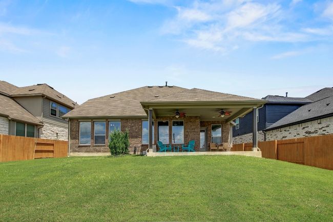 Back of house with ceiling fan, a fenced backyard, brick siding, a patio area, and a shingled roof | Image 33