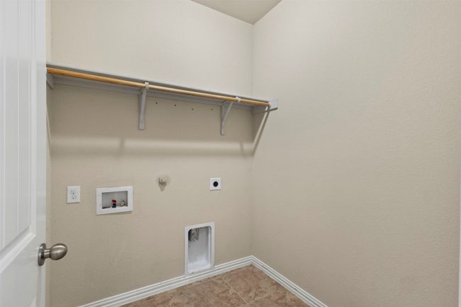 Washroom featuring electric dryer hookup, hookup for a gas dryer, washer hookup, and tile patterned flooring | Image 28