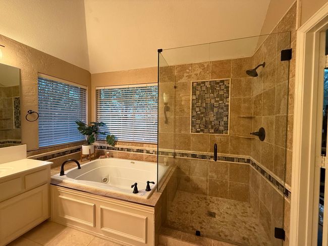Full bathroom with a jetted tub, vanity, tile patterned flooring, a shower stall, and lofted ceiling | Image 29