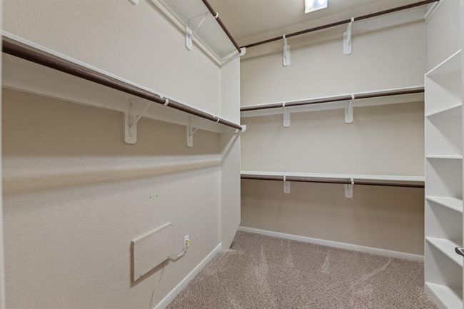 The walk-in closet offers plenty of space and built-in shelves. | Image 37