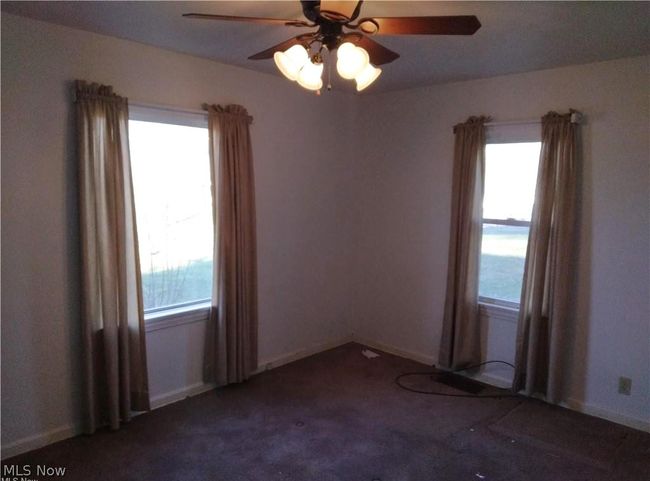 Unfurnished room featuring carpet flooring and ceiling fan | Image 7