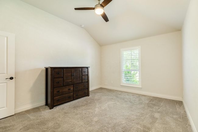 The home's secondary bedroom faces the side of the house. | Image 9