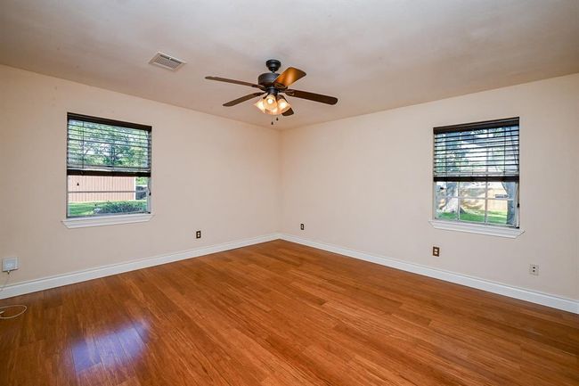The spacious master bedroom is located on the first floor and overlooks the backyard. | Image 16