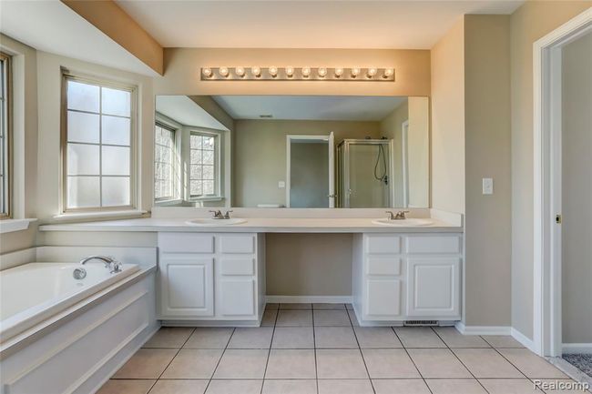 Jack and Jill bath shared by the upper bedrooms with dual sinks, jetted tub and large counter space. | Image 14