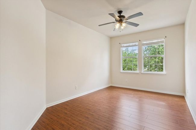 Spare room featuring a ceiling fan and wood finished floors | Image 32