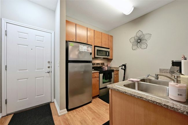 Kitchen with appliances with stainless steel finishes, sink, and light hardwood / wood-style floors | Image 5