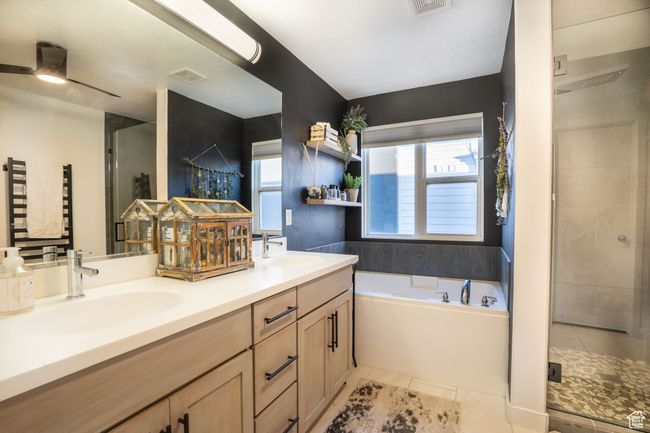 Bathroom featuring a large tub, double vanity, large custom shower -- come see! | Image 21