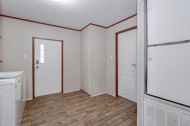 Main house - laundry room with room for a freezer, and backyard access | Image 22