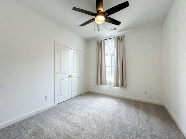 Unfurnished bedroom with carpet and a ceiling fan | Image 24