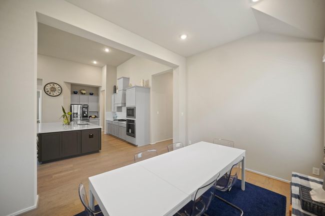 This dining room is bathed in naturallight streaming through expansivewindows. | Image 12