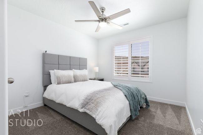 Carpeted bedroom featuring visible vents, a ceiling fan, and baseboards | Image 29