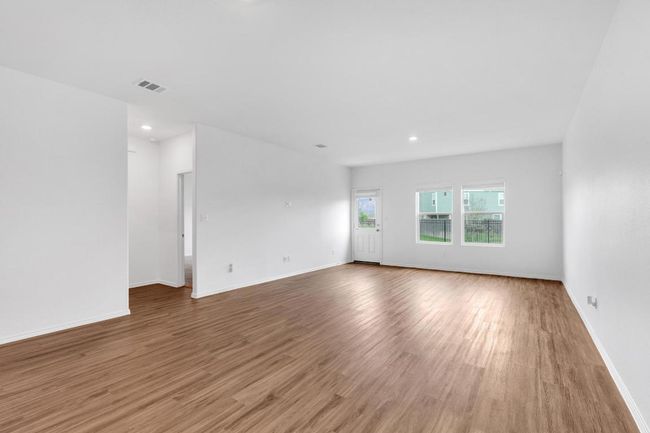 Unfurnished room with wood finished floors, baseboards, and visible vents | Image 9