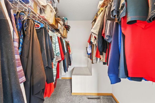Generous walk-in closet with built-in shelving and ample space for storage and organization. | Image 22