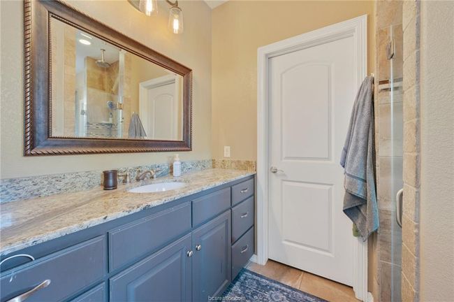 Bathroom featuring a shower stall, vanity, and tile patterned floors | Image 15