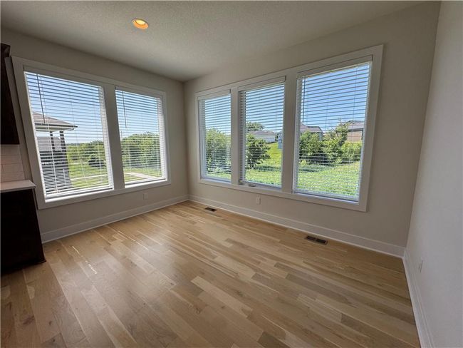 Unfurnished dining area featuring light wood-style flooring, a textured ceiling, and recessed lighting | Image 18