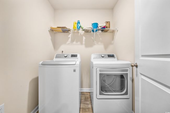 Washroom with independent washer and dryer, wood finished floors, and baseboards | Image 12